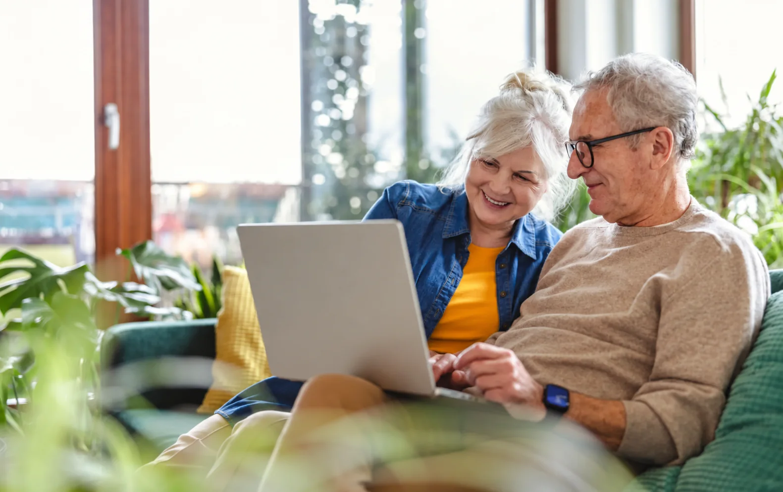 An older couple reviewing health information together at home
